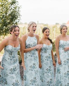 four bridesmaids laughing together in their dresses