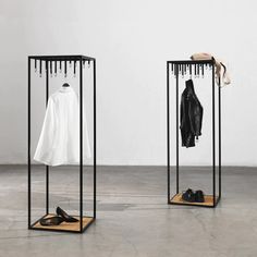 two black and white clothes racks with shoes on them, one in front of the other