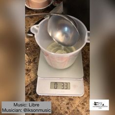 a kitchen scale with a measuring cup on it