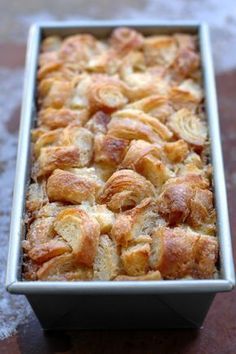 a pan filled with bread on top of a wooden table