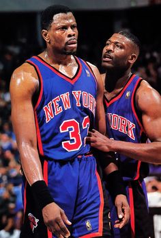 two basketball players standing next to each other