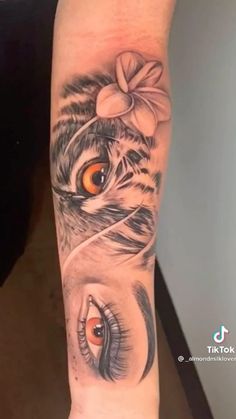 a woman's leg with tattoos on it and an eye in the center, which is