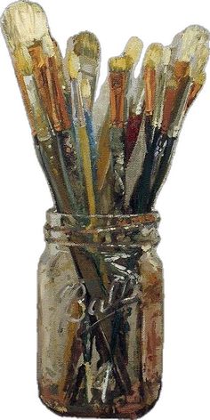 a jar filled with lots of paint brushes