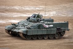 an army tank is driving through the mud