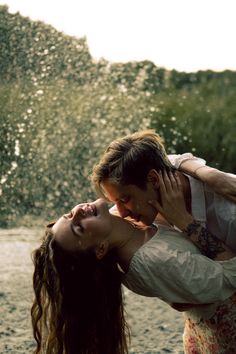 a man and woman are kissing in the water