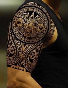 a man's arm with an intricate tattoo design on the side of his arm