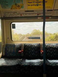 the seats are empty on the train as it passes through the window and onto the street