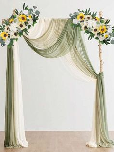 an arch decorated with sunflowers and greenery