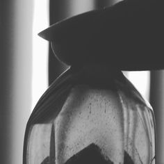 a black and white photo of an old fashioned blender with something in it's glass container