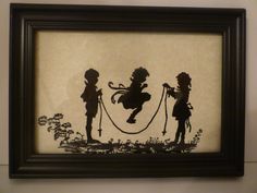 the silhouettes of two children are shown in a black frame on a white wall