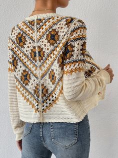 a woman wearing a sweater with an open back