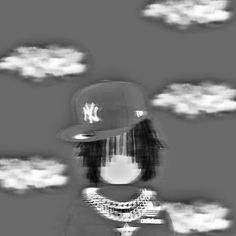 a person wearing a baseball cap and standing in front of clouds with the new york yankees on it