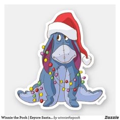 a blue dog wearing a santa hat and lights on it's tail, sitting in front of a white background