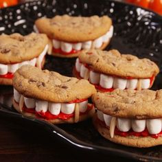 chocolate chip cookies with white marshmallows and red sauce on them are arranged in the shape of teeth