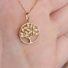 These shimmery symbolic tree Necklace feature 0.07Ctw of genuine diamonds, A valuable piece for yourself or a special gift for your loved ones! The Tree of Life symbol represents our personal development, uniqueness, and individual beauty. Just as the branches of a tree strengthen and grow upwards to the sky, we too grow stronger, striving for greater knowledge, wisdom, and new experiences as we move through life. ♥Details Height: 12mm Width: 12mm Thickness: 1.mm Stone material: genuine diamond Elegant Yellow Gold Tree Of Life Jewelry, Elegant Tree Of Life Jewelry For Anniversary, Elegant White Gold Tree Of Life Jewelry, Elegant Tree Of Life Necklace For Anniversary, Tree Of Life Symbol, Real Gold Necklace, Solid Gold Charms, Necklace Tree, Life Symbol