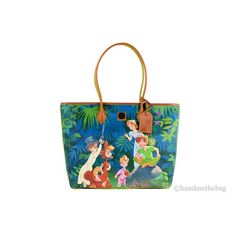 Style: Dooney & Bourke Disney Peter Pan Storybook Art Large Tote Bag Material: Coated Canvas Features: Cell Phone Pocket, 2 Inner Slip Pockets, 1 Inner Zip Pocket, Lined, Key Hook, 10.5" Handle Drop Allover Print Includes: Peter Pan, Wendy, John, Michael, Tinker Bell, the Lost Boys, and Colorful Never Land Foliage Measures: 14" W x 11.5" H x 6.75" D MSRP: $298 Color: Blue.  Gender: female.  Age Group: adult. Themed Multicolor Travel Bag, Blue Rectangular Bag For Disney Trips, Peter Pan Wendy, Dooney And Bourke Disney, Storybook Art, Key Hook, Tinker Bell, Lost Boys, Art Large