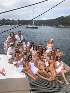 a group of people sitting on the back of a boat posing for a photo together