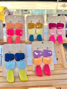 the colorful earrings are on display at the store for $ 5 each or more people to purchase