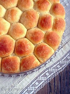 a baked dessert sitting on top of a glass platter next to a white doily