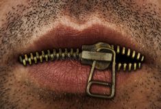 an open zipper on the side of a man's mouth with his tongue sticking out