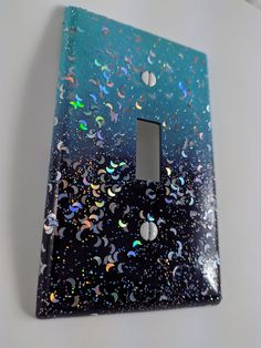 a light switch cover with multicolored confetti on it