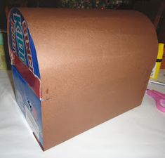 a brown mailbox sitting on top of a white table