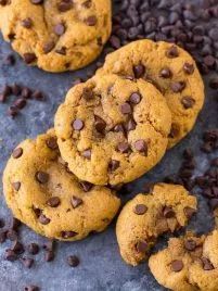 chocolate chip cookies on a table with chocolate chips