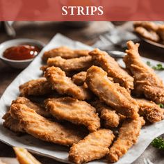 fried chicken strips on a plate with dipping sauce