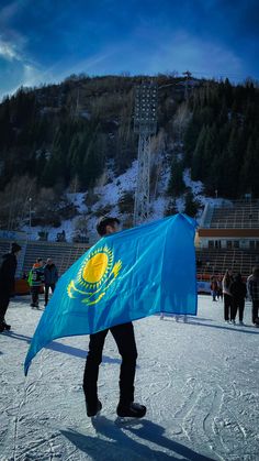 a man holding a flag in the snow