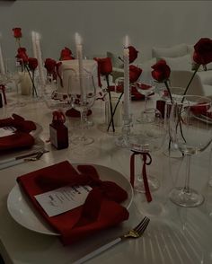 the table is set with red napkins and wine glasses