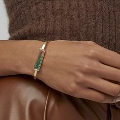 The Emerald Shaker Bangle in 18-karat gold is perfect to be worn by itself or to add a unique playfulness to your bracelet stack. Its elongated Kaleidoscope Shaker™ sits perfectly on the wrist and offers extra room for the round and baguette emeralds to slide. Complete the look with our Stacking Rose Cut Diamond Bangle. This bracelet is water-resistant*. To preserve this piece, consult the care instructions.  DescriptionBracelet with 1.40ct of emeralds enclosed in a Kaleidoscope Shaker™ in 18 karat yellow gold. Materials and Measurements• 1.40ct of Emeralds• 0.05ct of Diamonds• 18 Karat Yellow Gold• Shaker Size: 16x4 mm  Bangle Sizes• Small (54x40)• Medium (54x42)• Large (56x43 mm) Details• Made in New York City• Style # B879e • Closure: Concealed clasp Diamond Bangle, Small Details, City Style, October Birth Stone, Rose Cut Diamond, White Sapphire, Bracelet Stack, Gold Material, Rose Cut