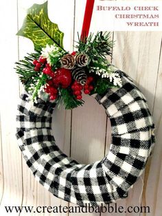 a christmas wreath hanging on the side of a wooden wall