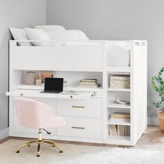 a white bunk bed sitting next to a desk with a laptop on top of it