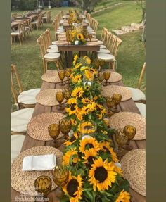 a long table with sunflowers and place settings