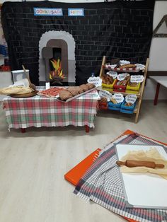 a table with food on it in front of a fireplace