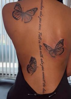 the back of a woman's body with butterflies on her upper and lower back