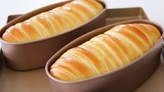 two loafs of bread sitting on top of a tray