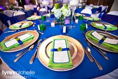 the table is set with blue and green place settings