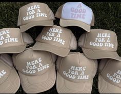 six hats that say, here for a good time and have been placed in the grass