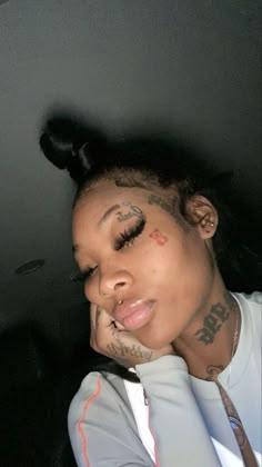 a woman with tattoos on her face and neck