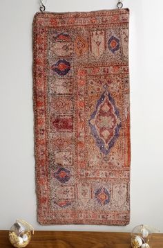 an old rug hanging on the wall