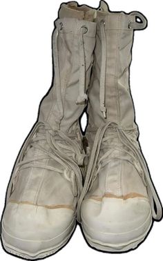 two pairs of white shoes with zippers on the bottom and one pair is closed