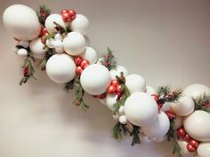 a christmas garland with red and white ornaments