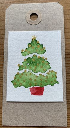 a card with a christmas tree painted on it