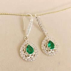 Gemstone :- Lab Created Emerald Stone Color:- Green Stone Shape:- Pear Stone size : 7x5 mm Metal :- Sterling Silver Side stone :- American Diamond / CZ Setting :- Bezel Setting Style :- Classic Length :- 3.5 cm Width :- 1.5 cm Closure :- Ear Wire Plating :- White Gold => Payment Policy We accept payment through PayPal. All payments must be made within 4 days of purchase. => Shipping Policy All Item will Be Shipped Through UPS, India Post International, DHL eCommerce or within 3-5 Business Cubic Zirconia Teardrop Earrings For May Birthstone, May Birthstone Teardrop Cubic Zirconia Earrings, Sterling Silver Teardrop Earrings With Sparkling Stones For Gift, Gift Sterling Silver Teardrop Earrings With Sparkling Stones, Sparkling Stone Pear Earrings As Gift, Pear-shaped Earrings With Sparkling Stones For Gift, Sterling Silver Teardrop Jewelry With Halo Design, Sterling Silver Pear-shaped Earrings With Sparkling Stones, Pear-shaped Sterling Silver Earrings With Sparkling Stones