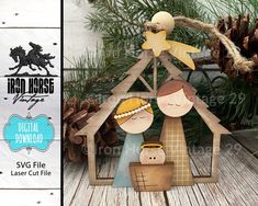 a wooden christmas ornament with a nativity scene in the center and pine cones