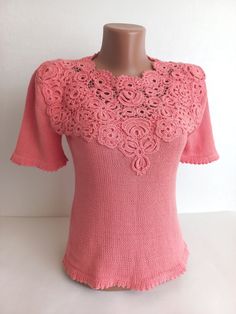 Introducing a charming addition to your wardrobe: a meticulously crafted crochet blouse exuding elegance and femininity.  This stunning women's blouse showcases the intricate artistry of Irish lace, elevating its allure with delicate motifs and fine craftsmanship. Fashioned in a soft, dreamy pink hue, this summer essential embodies grace and sophistication, perfect for warm-weather outings and leisurely strolls.  Handcrafted from premium cotton yarn, this crochet blouse offers comfort alongside Fitted Lace Top With Crochet Trim, Elegant Fitted Lace Top With Crochet Trim, Fitted Cotton Lace Tops With Crochet Trim, Elegant Short Sleeve Crochet Lace Blouse, Elegant Short Sleeve Blouse With Crochet Lace, Fitted Feminine Cotton Lace Top, Elegant Lace Knit Top For Spring, Spring Cotton Lace Crochet Top With Lace Work, Feminine Crochet Lace Blouse