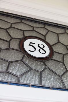 a close up of a glass door with a number on it