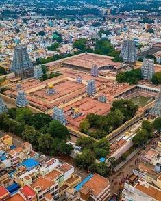 an aerial view of a city with many buildings and trees in the middle of it