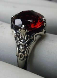 Simulated Red Ruby ring Paws Design#115 Custom made This is a Victorian reproduction ring in sterling silver with a lovely red gemstone. This high quality flawless Man-made red ruby has great shine and a lovely captivating color. The full cut approx. 3ct gemstone is 10mm (3/8th of an inch) in diameter. The inside of the band is marked 925 for sterling. Notice the beautiful floral antique design of the silver filigree setting and band. A gift ring box is included and all rings are shipped in the Classic Red Jewelry With Lab-created Ruby, Classic Red Lab-created Ruby Jewelry, Classic Red Ruby Jewelry, Classic Red Birthstone Ring, Classic Red Ruby Signet Ring, Classic Red Gemstone Signet Ring, Classic Red Jewelry With Round Cut, Classic Red Gemstone Crystal Ring, Elegant Red Sterling Silver Ring